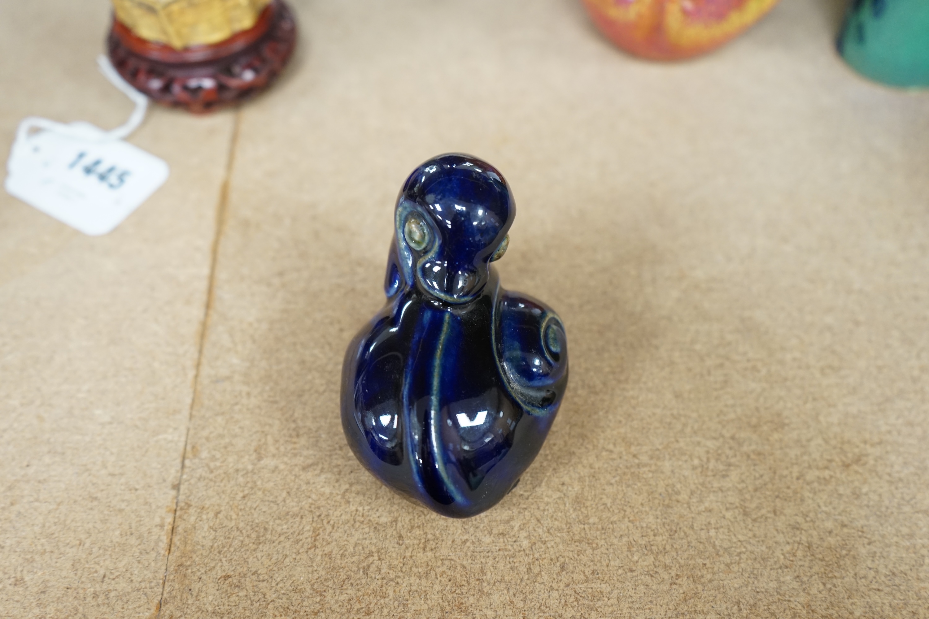 A Royal Doulton stoneware grotesque blue glazed 'duck' by Mark V. Marshall, 9cm wide. Condition - good